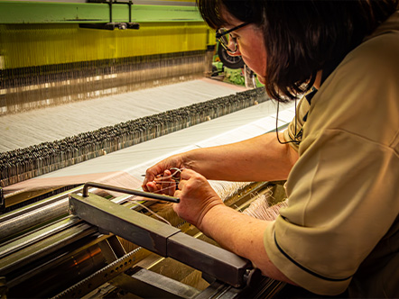 A weaver at her loom, Gérardmer Manufacture